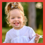 Toddler girl with hair in ponytail.